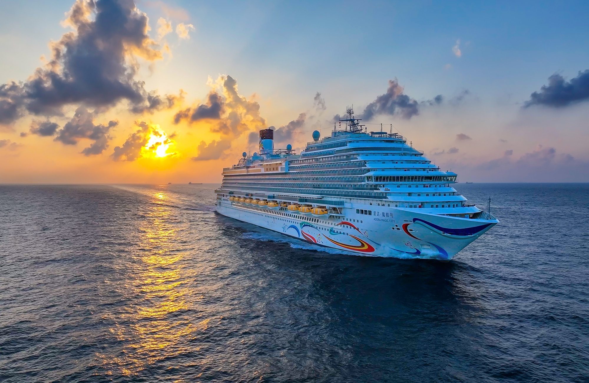 Adora Magic City at sunset with its colourful swirl hull art