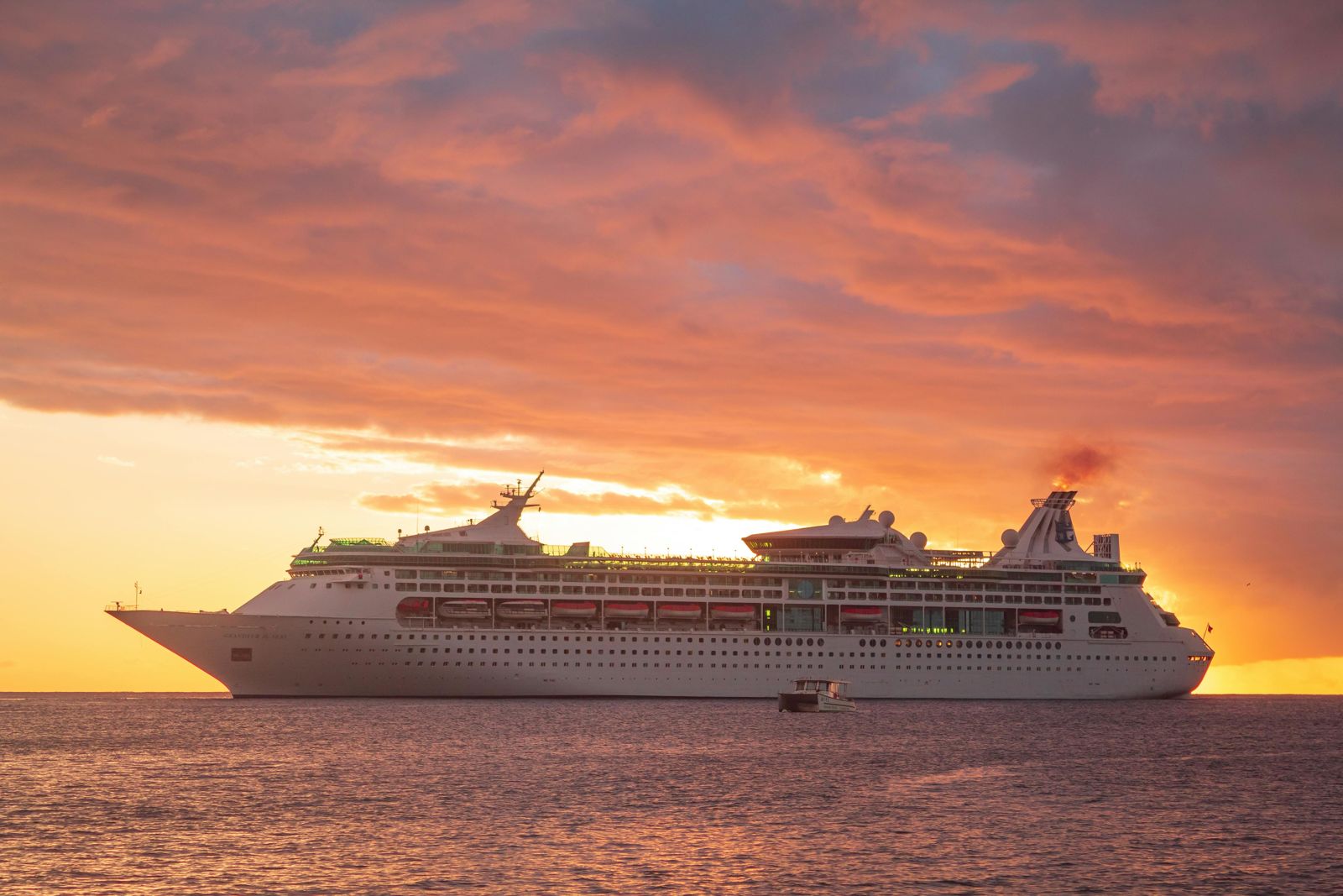 A cruise ship at sunset on calm water