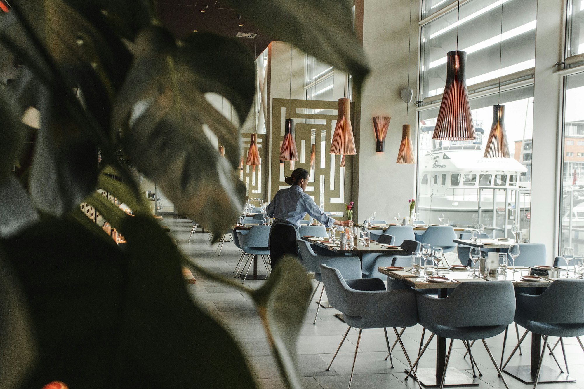 Hospitality service professional preparing a waterfront restaurant &mdash; the kind of career Jobs Kreate places talent into across Malaysia and beyond