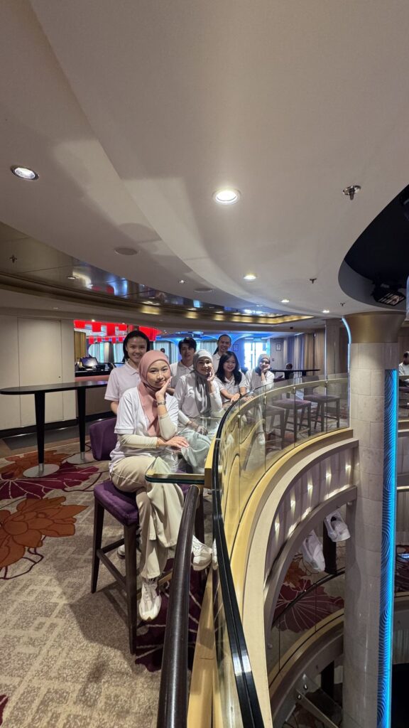Jobs Kreate team in an onboard atrium lounge of Genting Dream during the cruise visit.