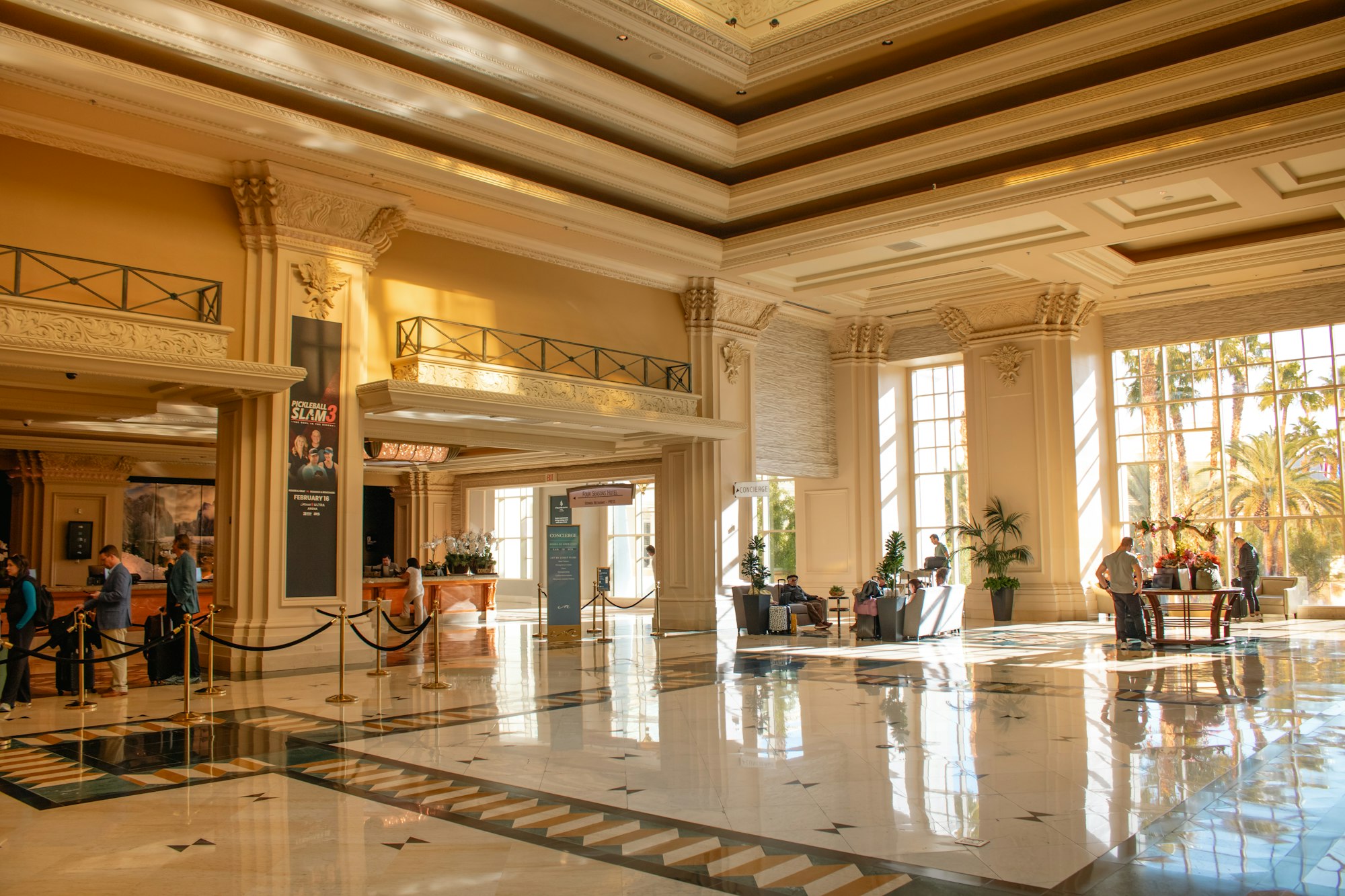 A grand, sunlit luxury hotel lobby