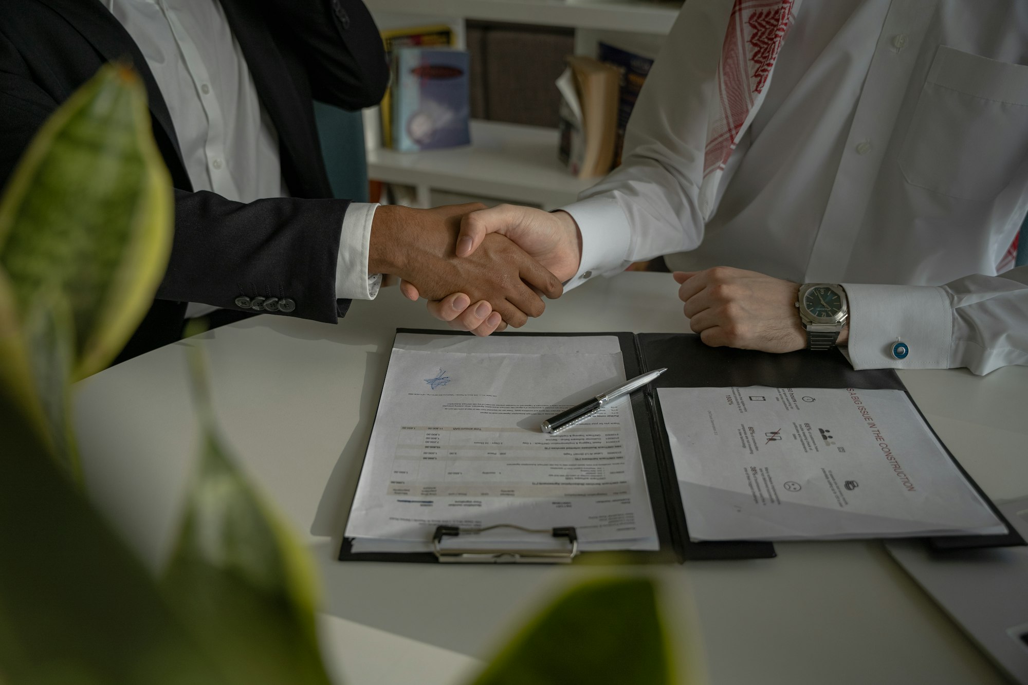A professional handshake at a job interview over a document