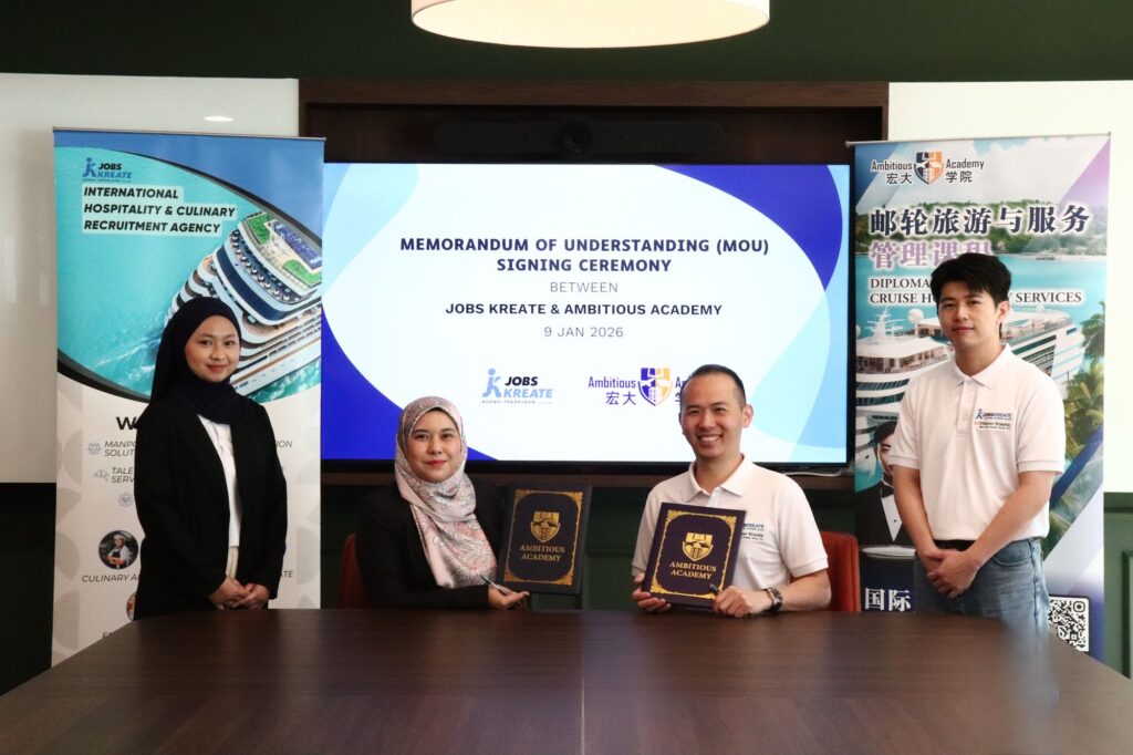 Jobs Kreate and Ambitious Academy representatives holding up the signed Memorandum of Understanding folders at the 9 January 2026 ceremony.