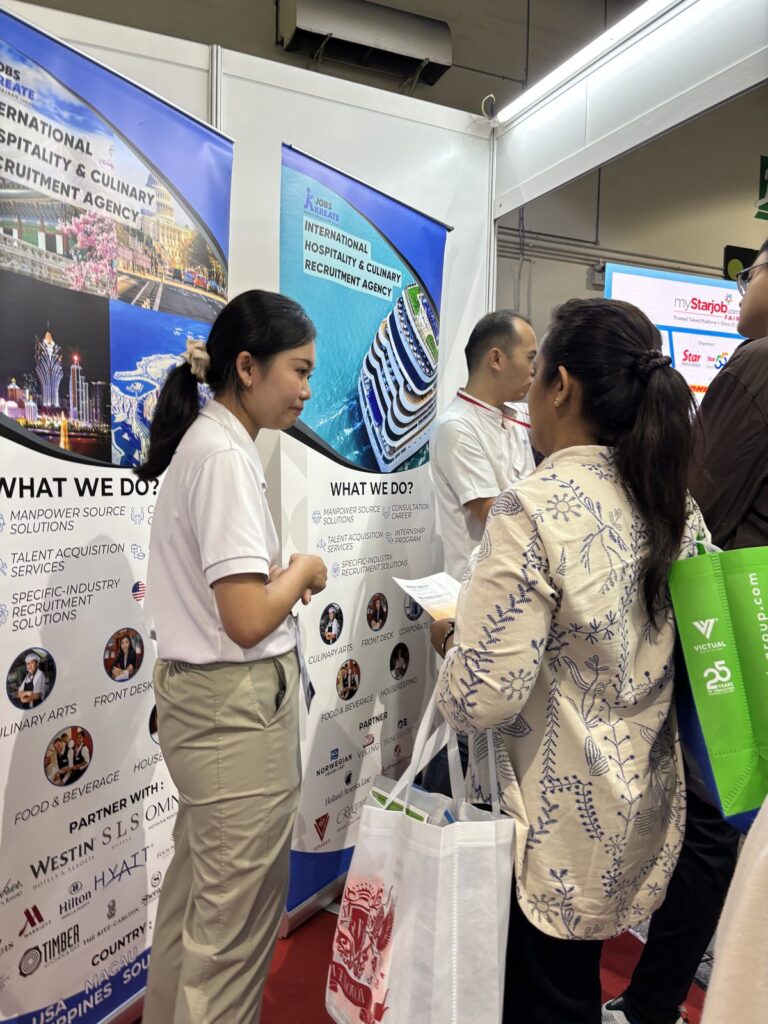 A Jobs Kreate consultant assisting a visitor at the Jobs Kreate services and partner-brand panel, Booth A30, myStarjob Fair 2026, Mid Valley Exhibition Centre Kuala Lumpur.