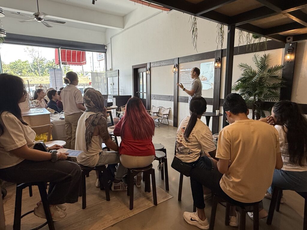 Keith from Jobs Kreate sharing cruise career insights with Sabahan attendees at the public sharing session held at Phileo Gelato, Kota Kinabalu.