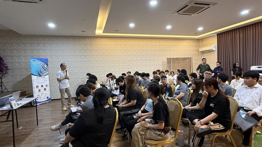 Keith Foo speaking to students beside the Jobs Kreate recruitment banner